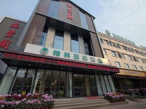 A hotel with a modern facade, large glass windows, and a prominent signage. - Greentree Inn Puyang Ruifengyuan Business Hotel (Puyang)