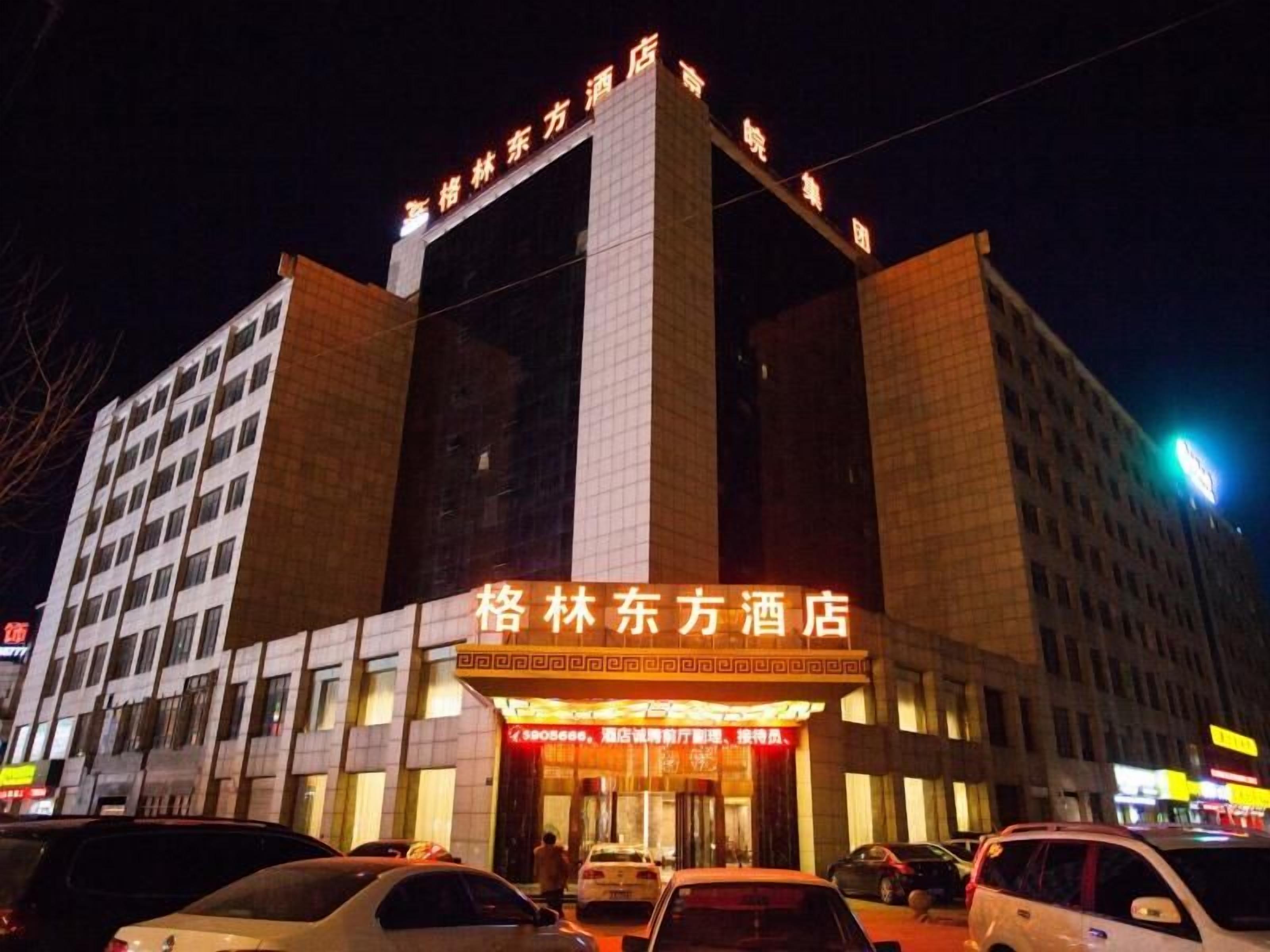 A hotel with a prominent entrance and signage.