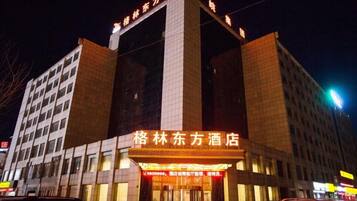 A hotel with a prominent entrance and signage.