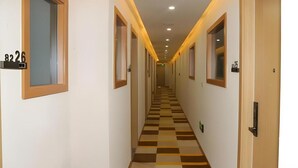A hotel hallway with checkered flooring, doors numbered 8226 and 8225, and a light-colored ceiling with recessed lighting. - Shell Lanzhou Zhongchuan Airport Hotel (Lanzhou)