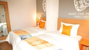 A hotel room with two beds, each with a white bedspread and orange pillows. There is a wooden floor, a nightstand with a lamp, and a wall with a Shell Hotel logo. - Shell Lanzhou Zhongchuan Airport Hotel (Lanzhou)