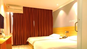 A hotel room with two beds, a desk, an air conditioning unit, and a wall with the text "ENJOY THE". - Shell Tai'an Taishan District Xinhuacheng International Plaza Hotel (Tai'an)