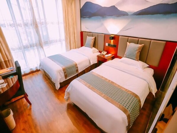 A hotel room with two beds, a desk, and a large window with curtains. - Greentree Inn Maanshan West Jiuhua Road Wanda Plaza Mengniu Diary Express Hotel (Ma'anshan)