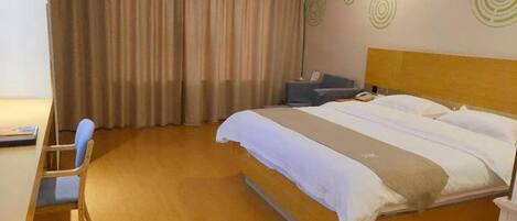 Una habitación de hotel con cama, escritorio, silla y cortina.