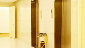 A modern elevator with a metallic finish and a glass panel. - Greentree Inn Wuxi Huishan District Yangshan Town Jiayang Life Plaza Business Hotel (Wuxi)