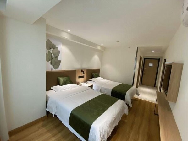 A hotel room with two beds, wooden flooring, a wall-mounted TV, and a door leading to another room. - Greentree Inn Handan Train Station Express Hotel (Handan)