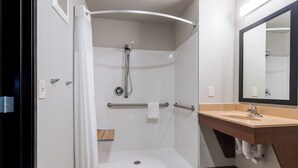 A bathroom with a shower, a sink, and a mirror. - My Place Hotel-pittsburgh North/monaca, PA (Monaca)