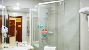 A hotel bathroom with a glass-enclosed shower, a sink, and a towel rack. - Greentree Inn Shandong Weifang Linqu Zhanqian Road Luchuan Business Hotel (Weifang)