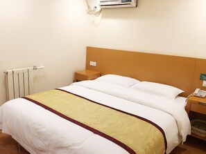 A hotel room with a single bed, a bedside table, a telephone, and a radiator. - Greentree Inn Tianjin Xiqing District Zhongbei Down Xiqing Road Shell Hotel (Tianjin)