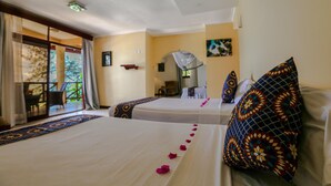 A hotel room with two beds, a balcony, and a view of greenery. - Sansi Kae Beach Resort (Michamvi)