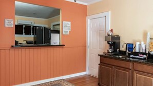 A hotel room with a kitchenette, a coffee machine, and a TV. - Rodeway Inn and Suites Walhalla SC (Walhalla)