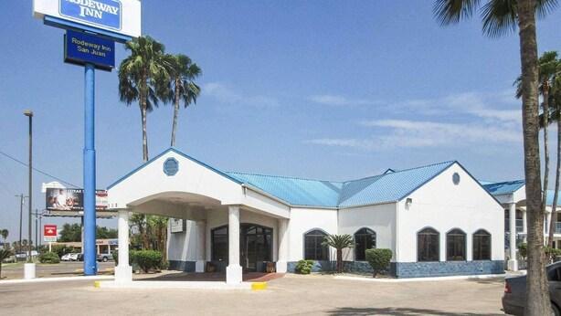 A Rodeway Inn with a blue roof and a covered entrance. - Rodeway Inn San Juan (McAllen)