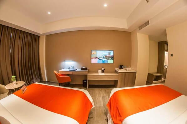 A hotel room with two beds, a desk, a TV, and a small table with a plant. - Acacia Hotel Davao (Davao)