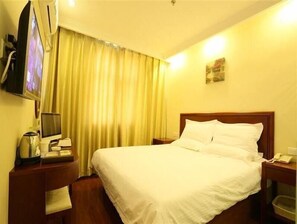 A hotel room with a bed, a television, a desk with a telephone, and a window with curtains. - Greentree INN Beijing Fengtai Yungang Road Express (Beijing)