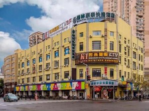 A multi-story building with various commercial establishments on the ground floor, including a KTV and a discount store. - Greentree Inn Shanghai East Xietu Road Jiuyuan Express Hotel (Shanghai)