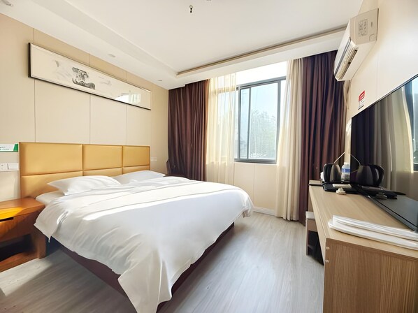 A hotel room with a large bed, a desk with a television, and a window with curtains. - Shells Shanghai Minhang District Pujiang Town Zhuyuan Road Hotel (Shanghai)