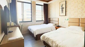 A hotel room with two beds, a desk, a chair, and a window with a view of buildings. - Shells Shanghai Minhang District Pujiang Town Zhuyuan Road Hotel (Shanghai)
