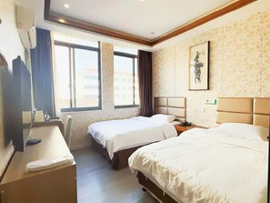 A hotel room with two beds, a desk, a chair, and a window with a view of buildings. - Shells Shanghai Minhang District Pujiang Town Zhuyuan Road Hotel (Shanghai)