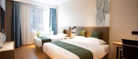 A modern hotel room with two single beds, a desk, and a large window with curtains.