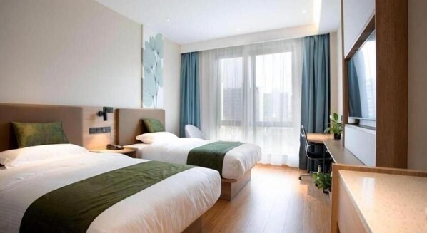 A hotel room with two beds, a desk, and a large window with curtains. - Greentree Inn Express Shanghai Pudong Lingang New City Yunhan Road (Shanghai)