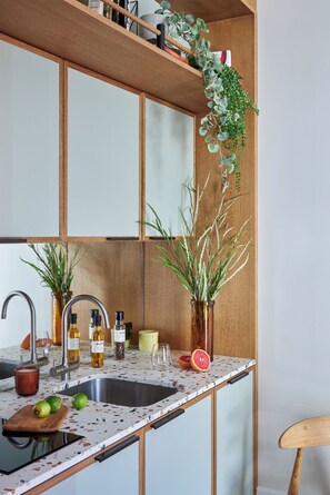 A kitchen with a wooden countertop, a sink, and various kitchen items. - Turing Locke, Eddington (Cambridge)