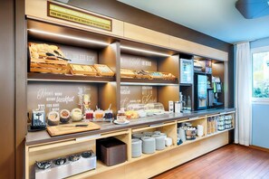 A breakfast buffet with various food items and condiments.