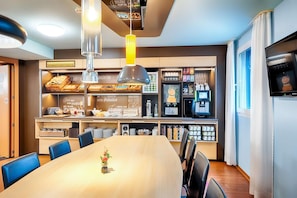 A modern breakfast bar with a variety of food items and a coffee machine. - B&B Hotel Köln-frechen (Frechen)