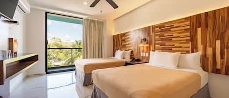 A hotel room with two beds, a ceiling fan, a TV, a balcony with a view, and a wooden wall panel.
