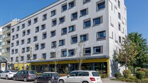 A modern hotel building with multiple floors and a row of windows. - B&B Hotel München City-west (Munich)