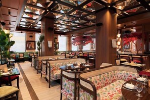 A restaurant with wooden paneling, high ceilings, and a variety of seating options including booths and tables. - Radio Hotel (New York)