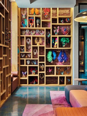 A room with a brick wall and wooden shelving filled with various decorative items. - Radio Hotel (New York)