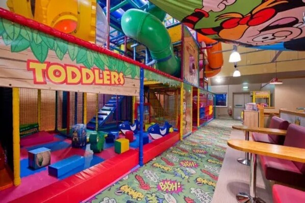 A play area for toddlers with colorful play structures and a slide. - Premier Inn Norwich East Hotel (Norwich)