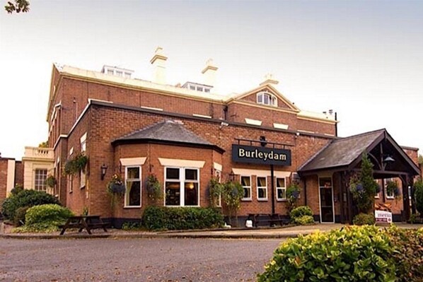 A brick building with a sign reading "Burleydam." - Premier Inn Wirral (Ellesmere Port)