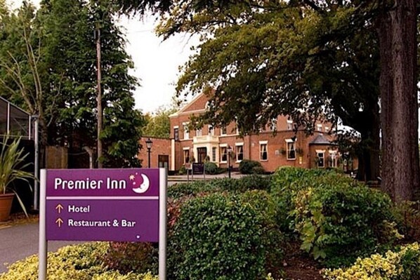A sign for Premier Inn indicating the direction to the hotel and restaurant & bar.