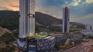 A modern hotel complex with multiple high-rise buildings, a landscaped rooftop, and a busy road in the foreground. - Staycation KL - The Ridge Apartments (Kuala Lumpur)