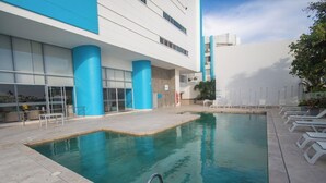 A swimming pool with a modern building in the background.