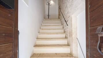 A staircase with white steps leading up to a landing.