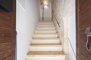 A staircase with white steps leading up to a landing.