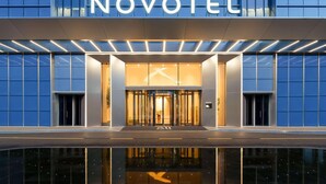 A modern hotel entrance with a prominent 'NOVOTEL' sign above the doors. - Novotel Xiamen Downtown (Xiamen)