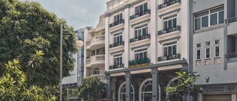 A multi-story building with a sign for "Hyatt Regency" and "SeHan Academy" on the ground floor.