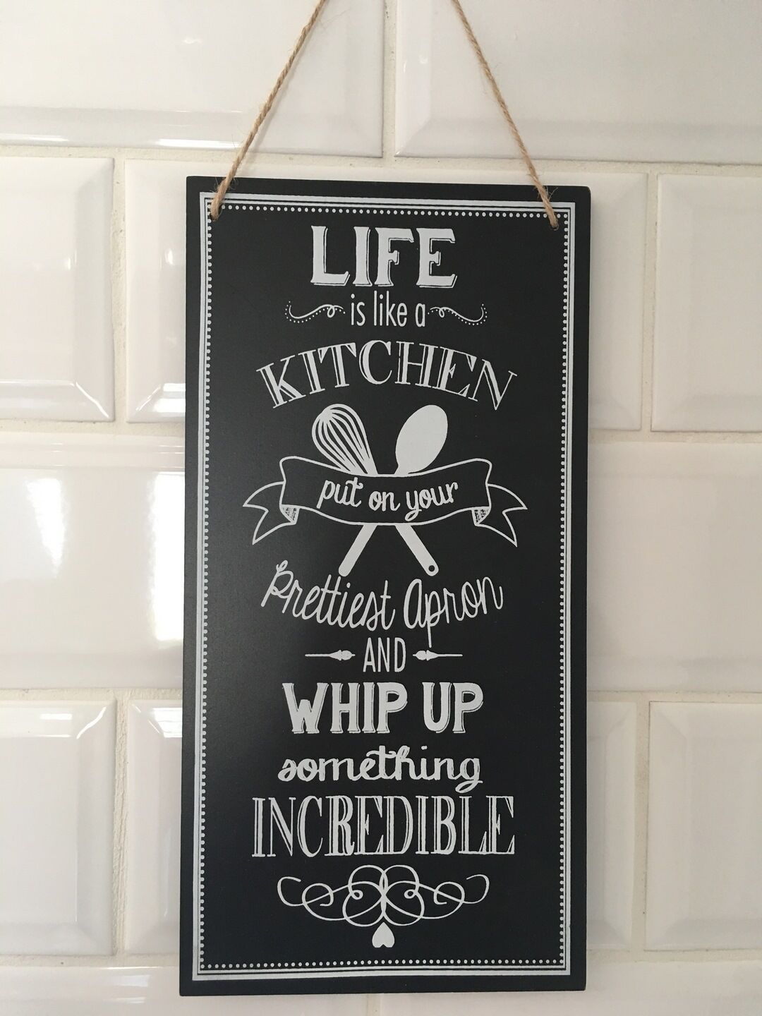 A kitchen-themed sign with a motivational message.