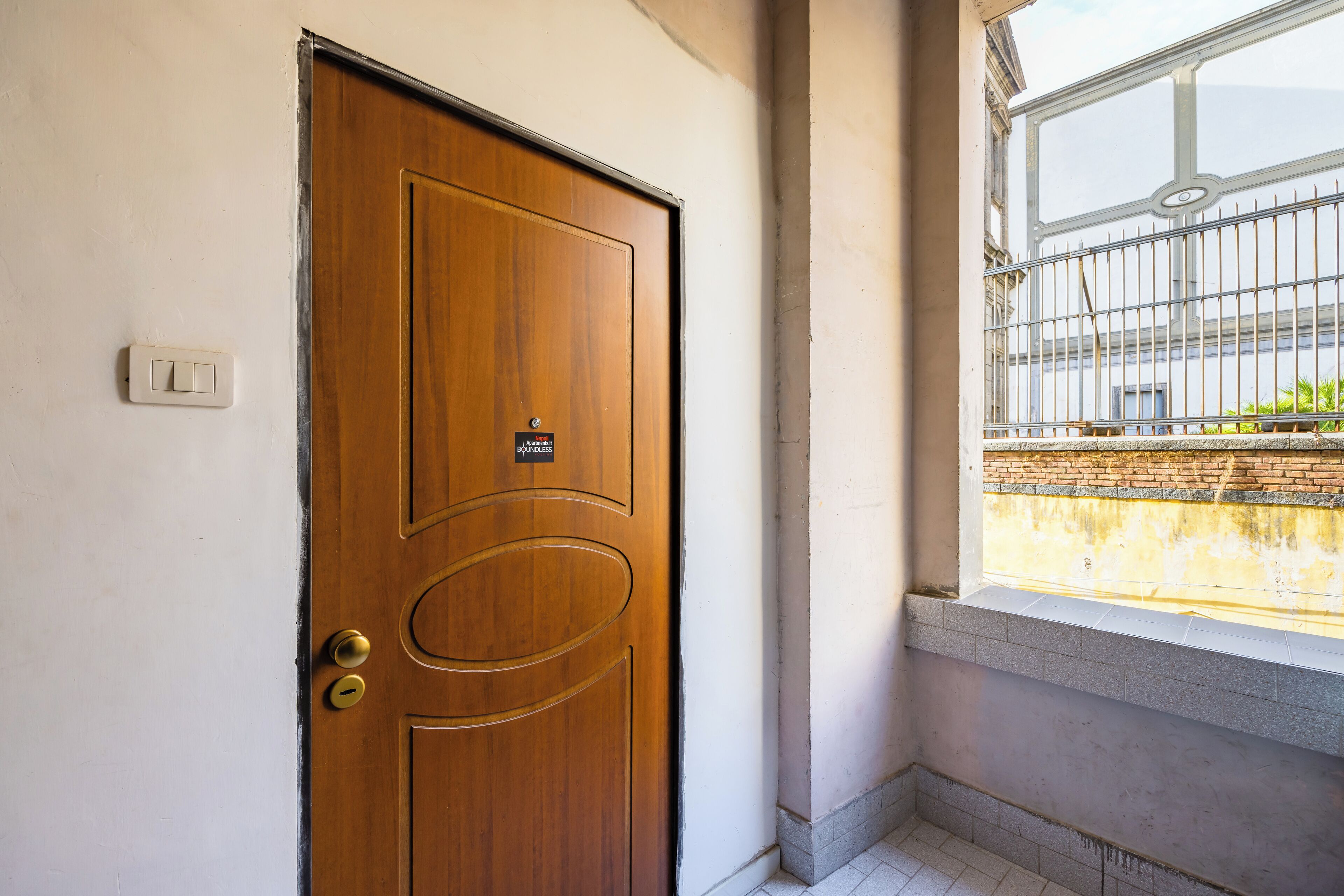 A wooden door with a brass handle and a sign that reads "No Entry."