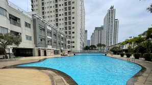 A swimming pool surrounded by high-rise residential buildings.