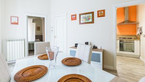 A modern kitchen with a stove, oven, and a white countertop. - Napoli Heartbeat by Napoliapartments (Naples)