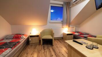 Standard Twin Room | Living area | 15-cm TV with cable channels