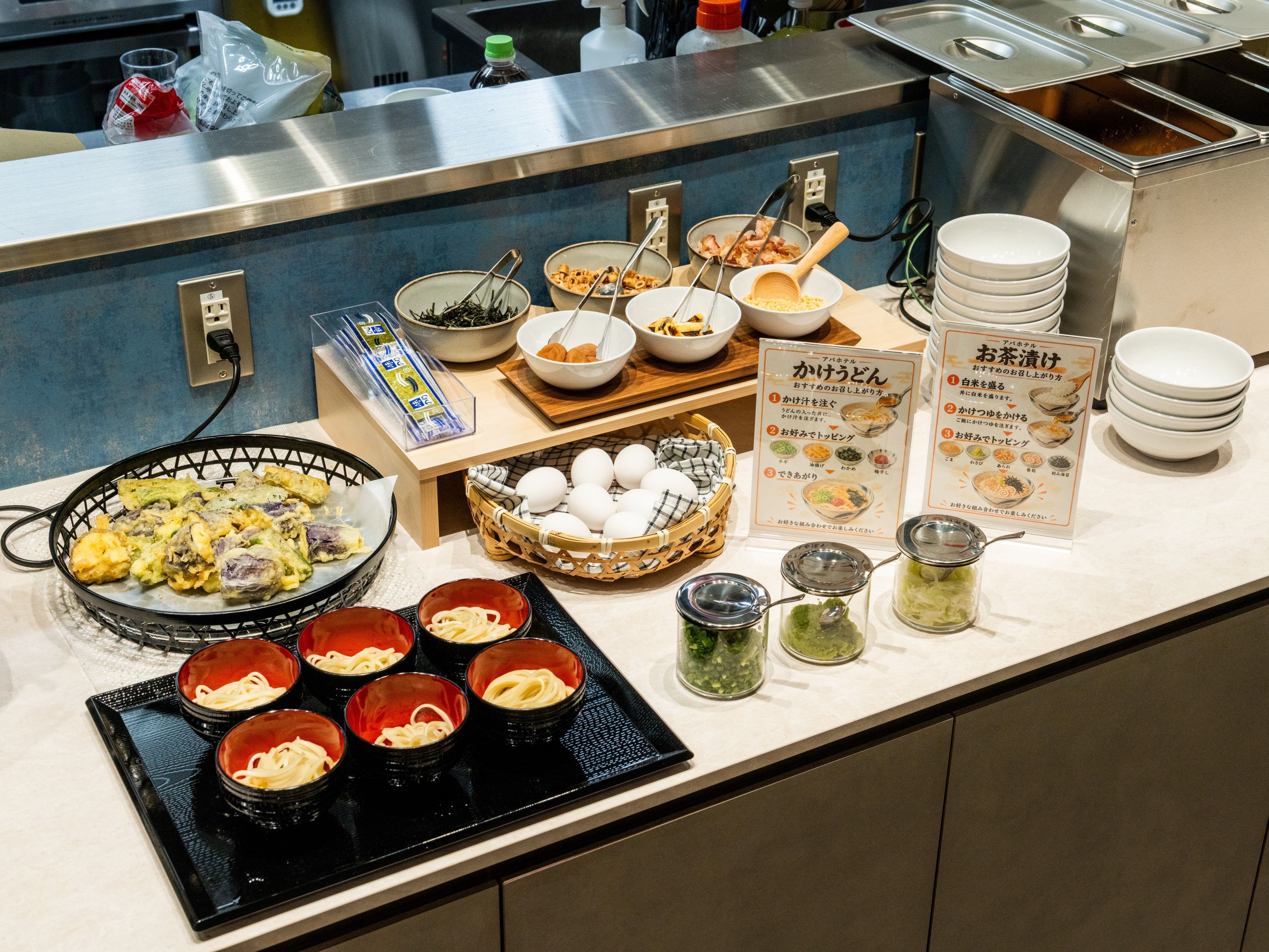 A buffet setup with various food items and condiments.
