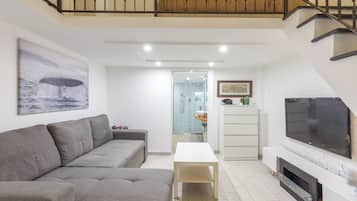 Apartment (1 Bedroom) | Living area | 32-inch TV with cable channels