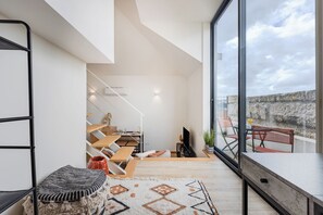 Romantic Duplex, 1 Double Bed, Balcony, City View | Living area | 32-inch TV with cable channels