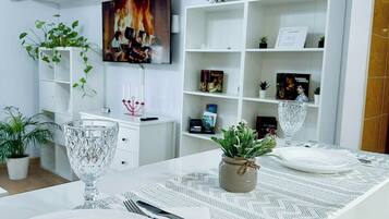Panoramic Apartment, Balcony, City View | Living area | 123-cm Smart TV with cable channels, Netflix, pay movies