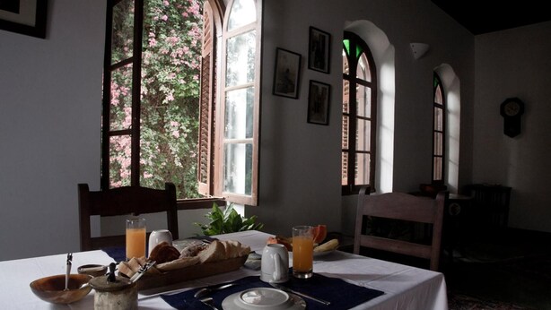 A breakfast table set with bread, a jug, and a glass of orange juice. - Hiliki House (Zanzibar Town)